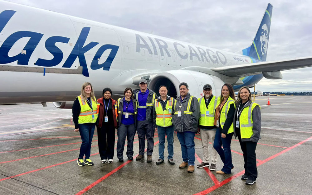 Alaska and Hawaiian Air Cargo teams in front of a freighter at Sea-Tac International Airport