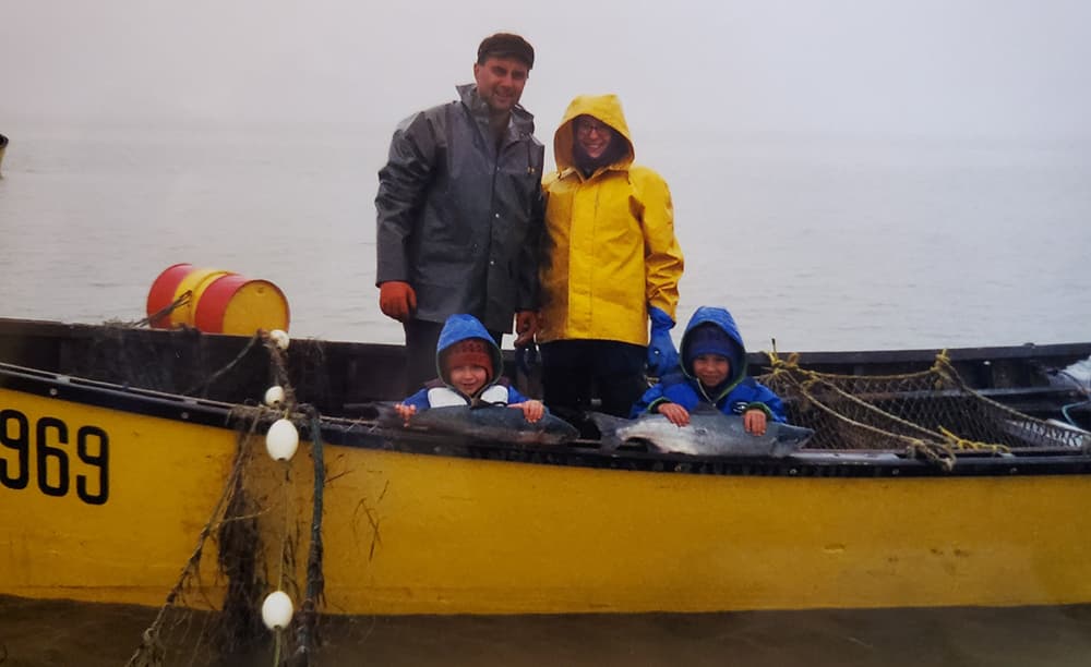 Ben Smith with his dad, mom and brother in a skiff
